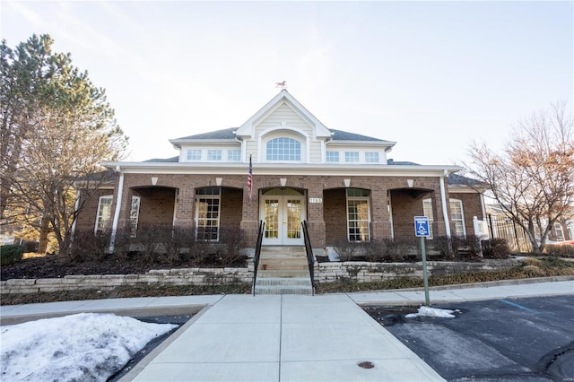 view of front facade with french doors and a porch