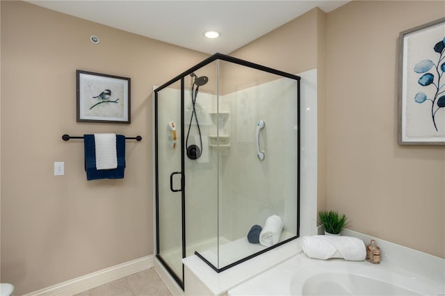 bathroom with tile patterned floors and a shower with door