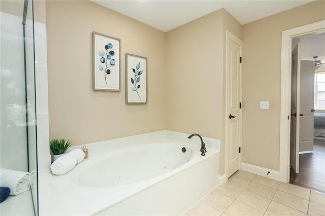 bathroom with tile patterned floors and a tub