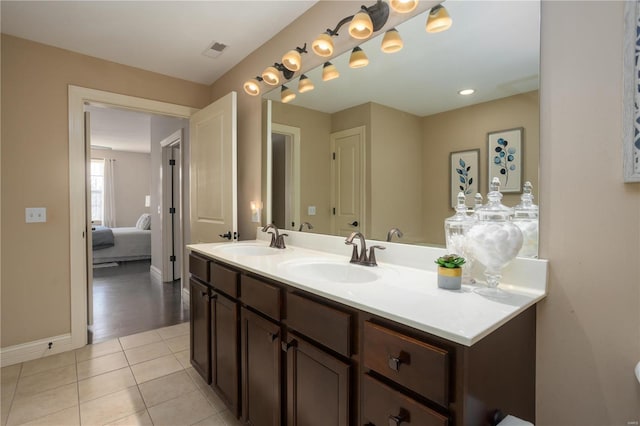 bathroom featuring tile patterned flooring and vanity