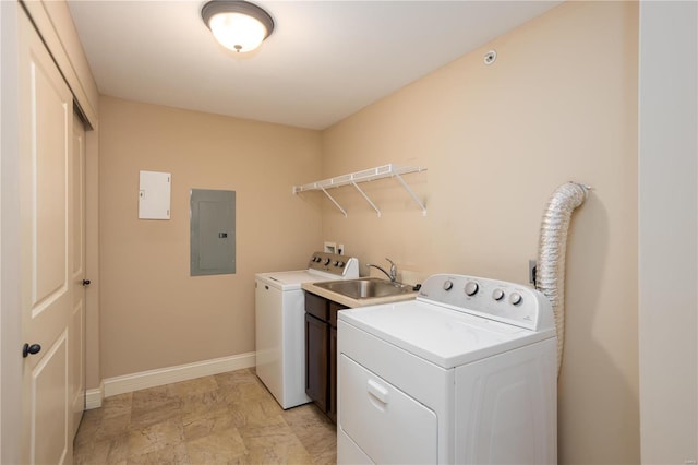 laundry area with sink, electric panel, and washing machine and clothes dryer