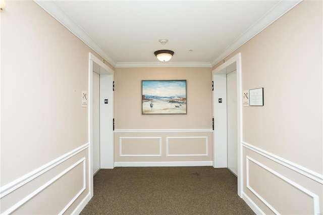 hall with elevator, ornamental molding, and dark carpet