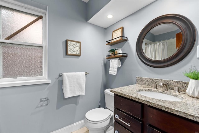 bathroom featuring vanity and toilet