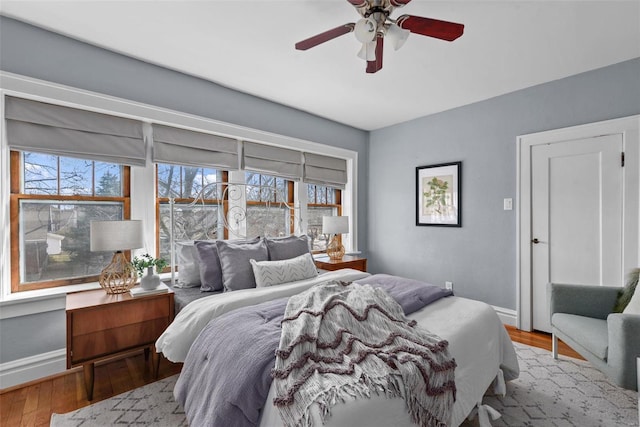 bedroom with ceiling fan and light hardwood / wood-style flooring