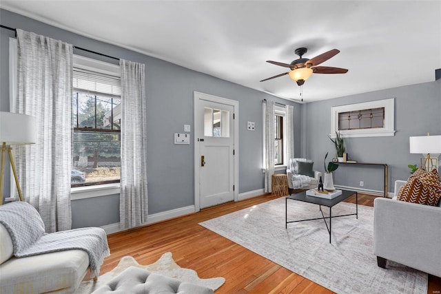 living room with hardwood / wood-style flooring and ceiling fan