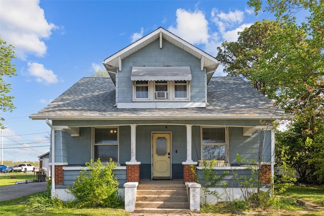 view of front of house with covered porch and roof with shingles