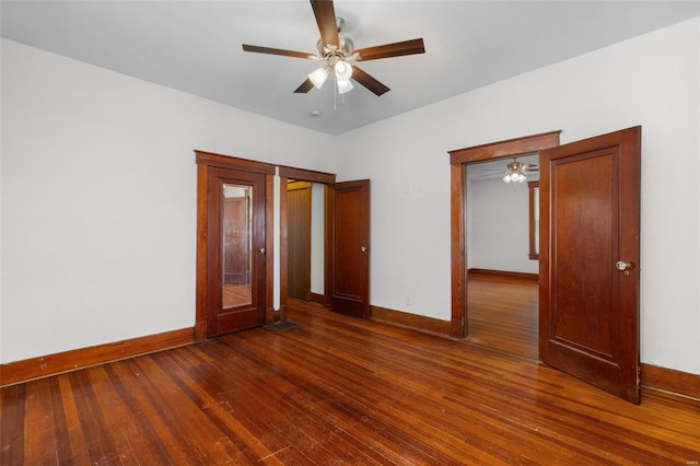 unfurnished bedroom with a ceiling fan, baseboards, and wood finished floors