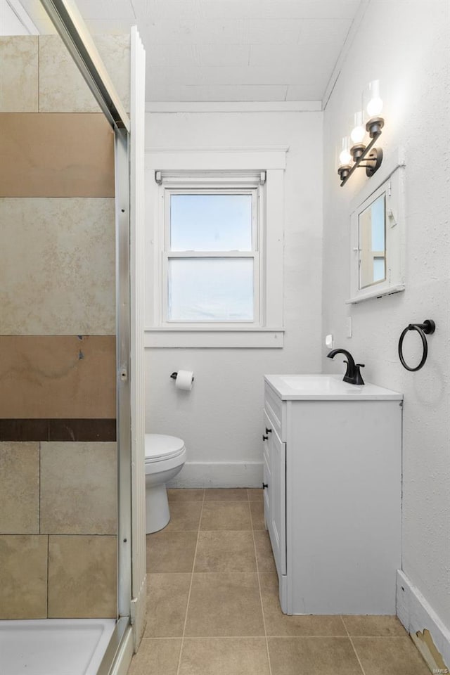 full bathroom with vanity, tile patterned flooring, toilet, and a shower stall