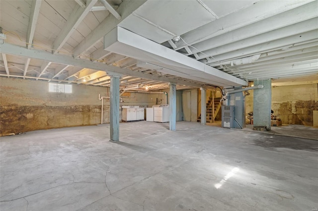 basement with heating unit and washer and dryer