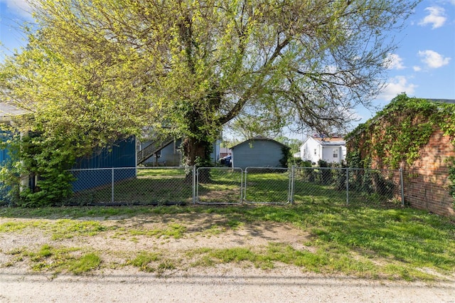 view of yard featuring fence and a gate
