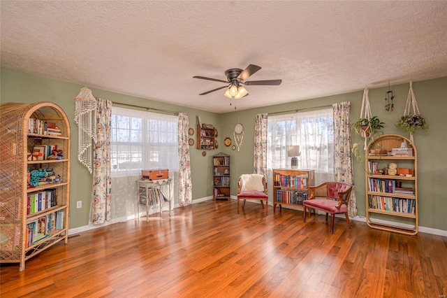 unfurnished room featuring wood-type flooring, plenty of natural light, and a textured ceiling