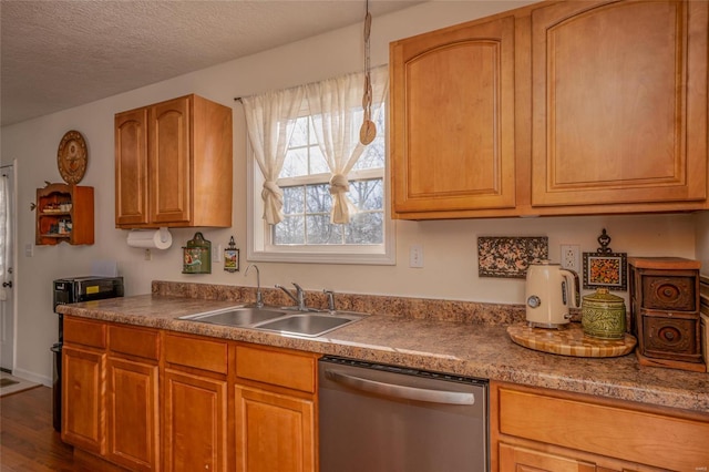 kitchen with sink, stainless steel dishwasher, a textured ceiling, and dark wood-type flooring