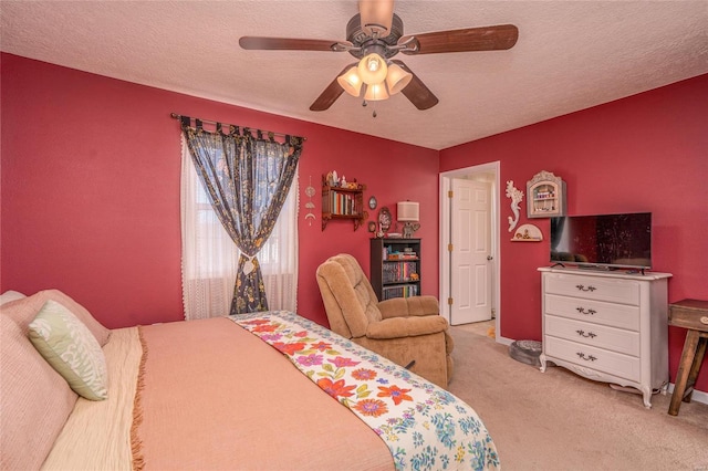 carpeted bedroom with ceiling fan and a textured ceiling