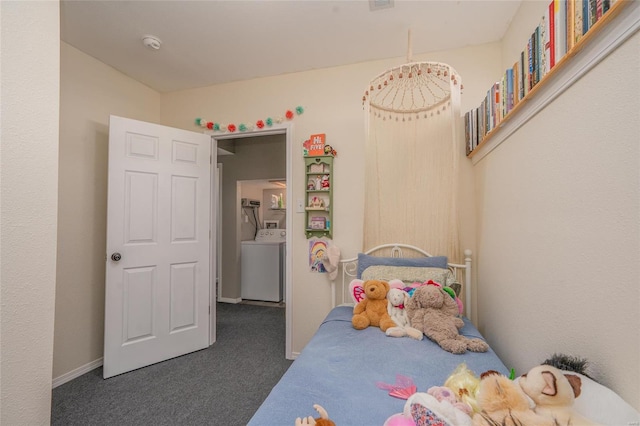 bedroom with washer / clothes dryer and dark colored carpet