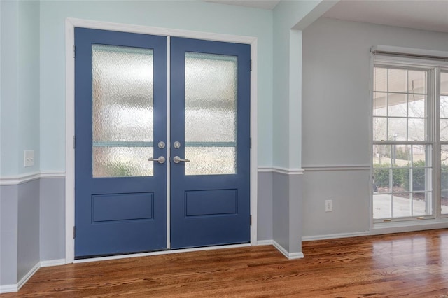 entryway featuring baseboards and wood finished floors