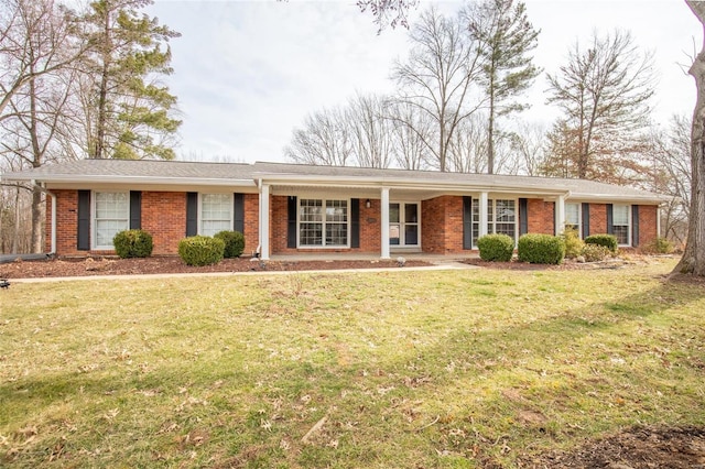 ranch-style home featuring a front yard and brick siding