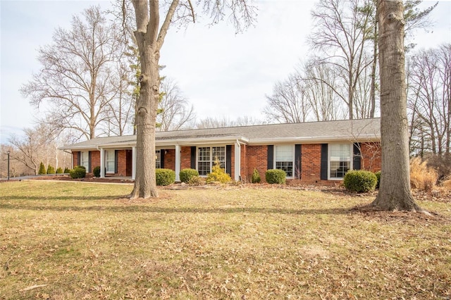 single story home with brick siding and a front yard