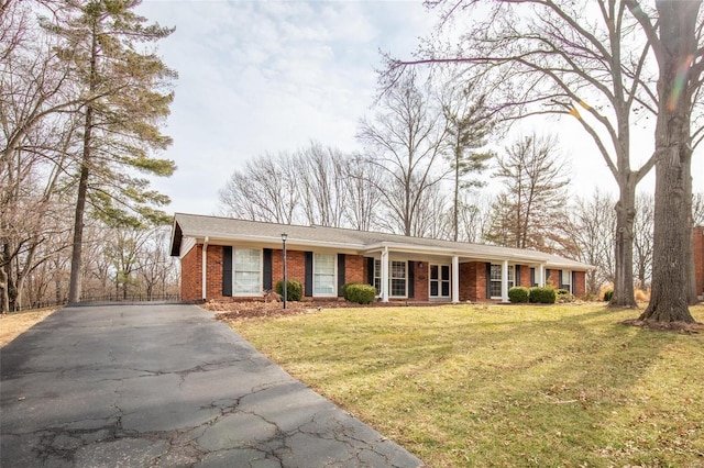 ranch-style house with a front yard, aphalt driveway, and brick siding