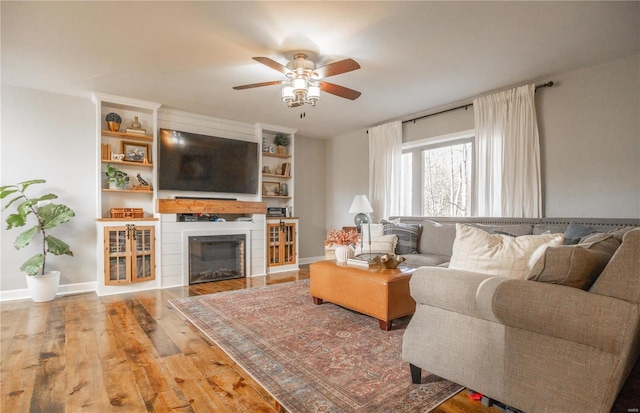 living room featuring ceiling fan and light wood-type flooring