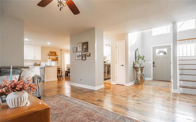 entrance foyer with ceiling fan and light wood-type flooring