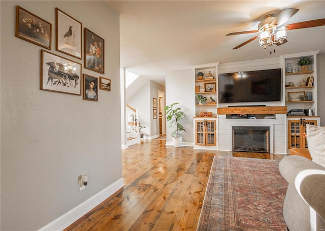 living room featuring hardwood / wood-style flooring and ceiling fan