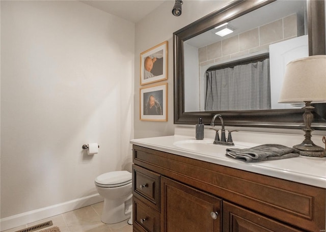 bathroom with tile patterned floors, toilet, and vanity