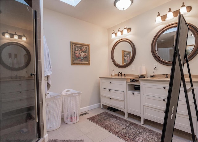 bathroom featuring vanity, tile patterned flooring, a skylight, and walk in shower