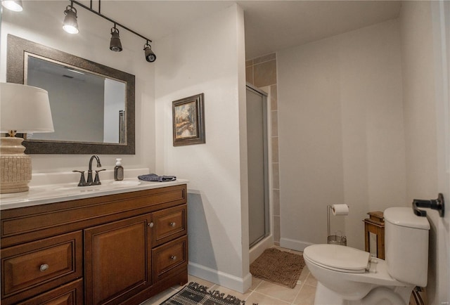 bathroom featuring vanity, toilet, a shower with shower door, and tile patterned flooring