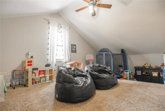 playroom with vaulted ceiling, carpet flooring, and ceiling fan