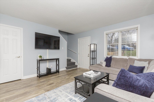 living room featuring hardwood / wood-style flooring and a textured ceiling