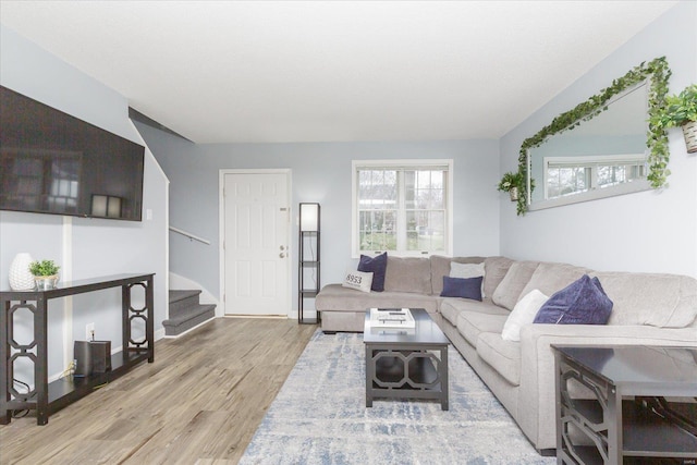 living room with plenty of natural light and light hardwood / wood-style flooring