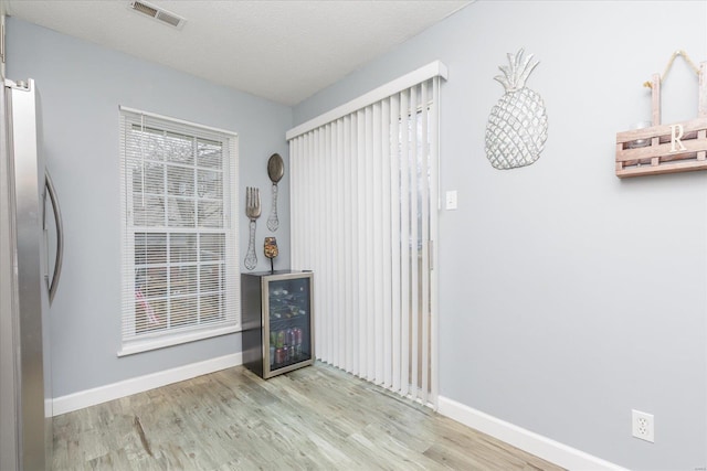 interior space with light hardwood / wood-style flooring and a textured ceiling