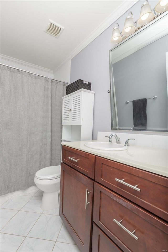 bathroom with crown molding, vanity, and toilet