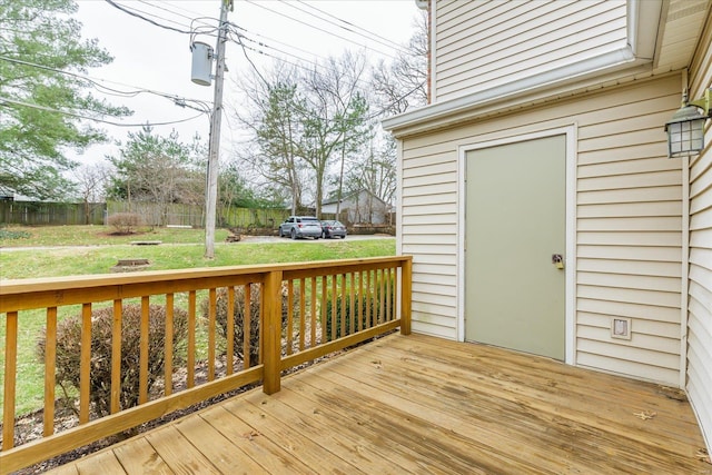 wooden terrace with a lawn