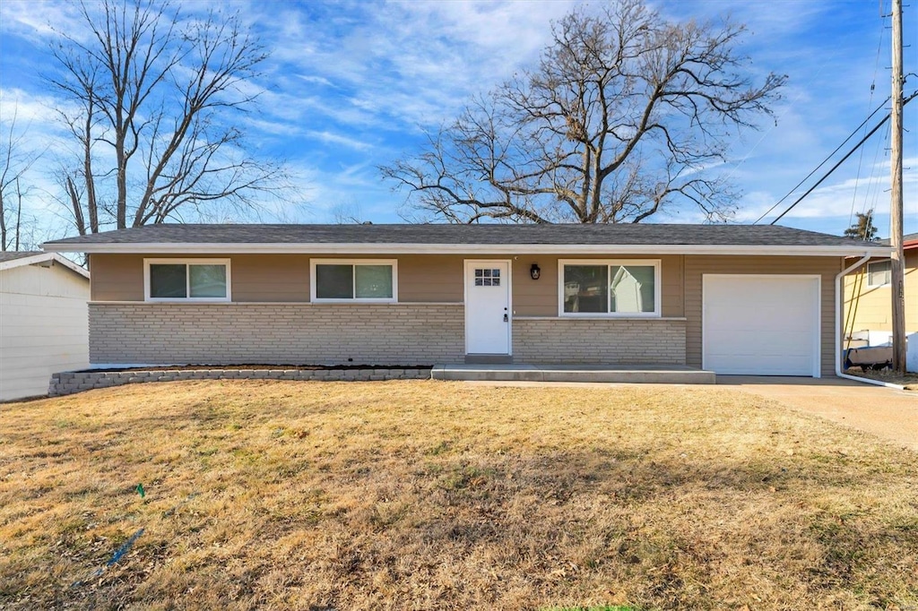 ranch-style house with a garage and a front yard