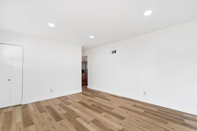 empty room with light hardwood / wood-style floors