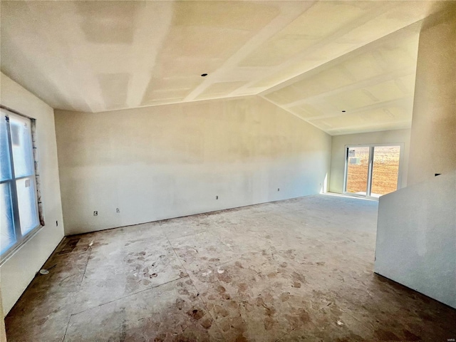 spare room featuring vaulted ceiling