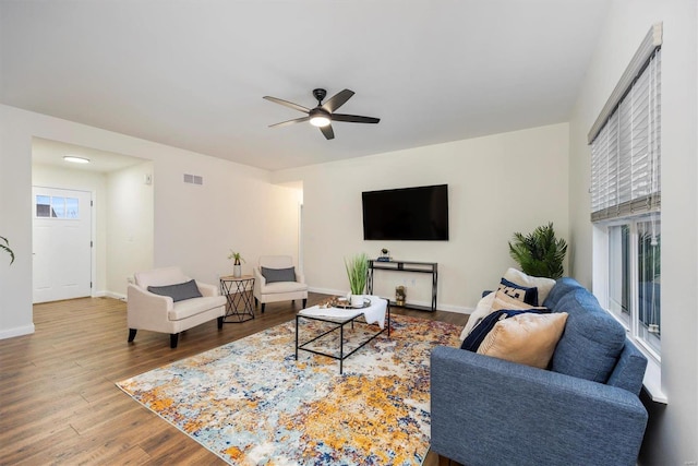 living room featuring wood-type flooring and ceiling fan