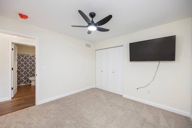 unfurnished bedroom featuring a closet, ceiling fan, and carpet