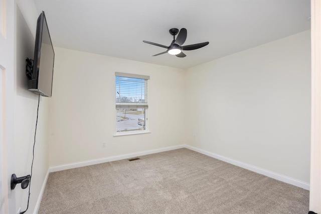 carpeted spare room with ceiling fan