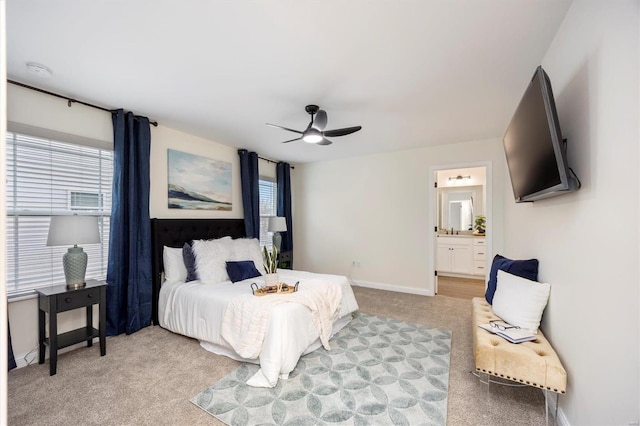 carpeted bedroom featuring ensuite bath and ceiling fan