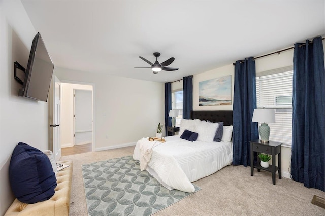 carpeted bedroom with multiple windows and ceiling fan