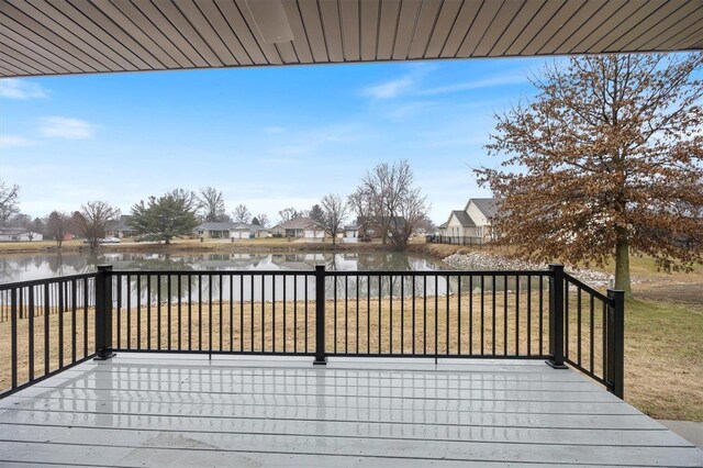 wooden deck featuring a water view and a yard