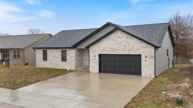 view of front of property featuring a garage and a front yard