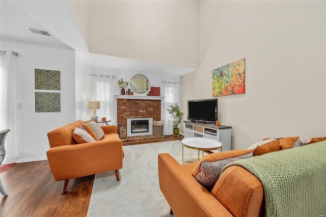 living room featuring wood-type flooring and a fireplace