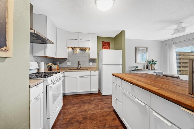 kitchen with sink, wooden counters, backsplash, white cabinets, and white appliances