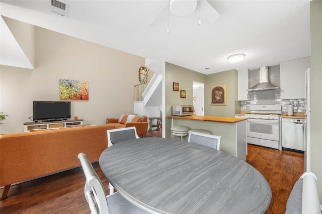 dining space featuring ceiling fan and dark hardwood / wood-style floors