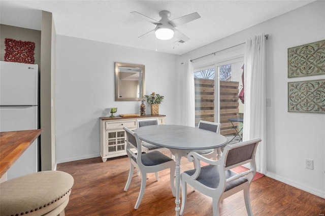 dining room featuring ceiling fan, dark hardwood / wood-style flooring, and a textured ceiling