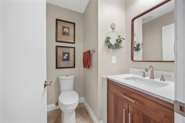 bathroom featuring vanity, toilet, and tile patterned flooring