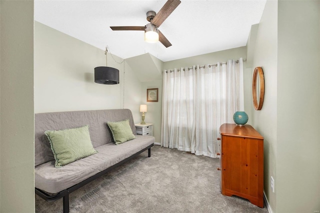 living area featuring ceiling fan, light colored carpet, and vaulted ceiling